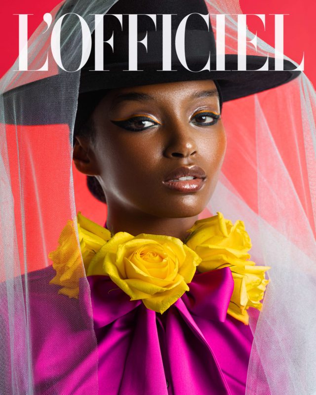 L’Officiel Austria beauty editorial with a model in a hot-pink top and yellow roses