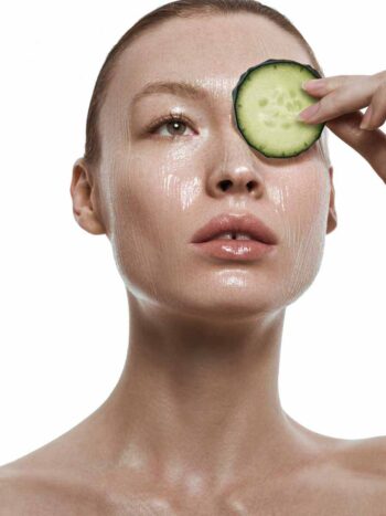 Viki Foti holding a cucumber slice over one eye, Marie Claire Indonesia skin-care story
