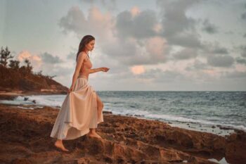 Schaeffer Studios Fashion Photographer Featuring Zorelys Lisboa Walking on Rocks by Ocean